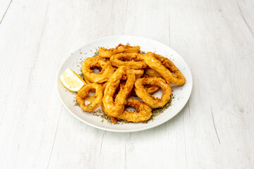 Serving of Andalusian squid with lemon and oregano