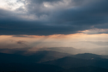 sunset in the mountains with sunbeams