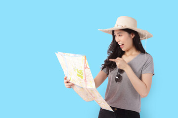 beautiful asian woman wearing a hat and holding a tourist map Standing on a blue background. travel concept. Clipping Path