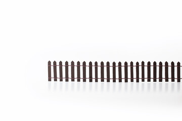 Building wall, fence , or obstacle. Miniature picket fence isolated on white background. Concept...