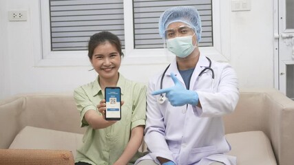 Asian young woman in medical mask show app smartphone mobile digital screen vaccinated coronavirus (COVID-19) certificate after getting vaccine prevent and doctor pointing to confirm certificate - Powered by Adobe