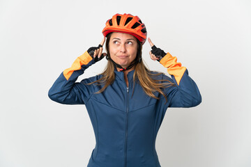 Middle age cyclist woman isolated on white background having doubts and thinking