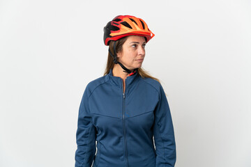 Middle age cyclist woman isolated on white background looking to the side