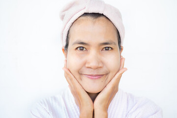 Face woman no makeup close up on white background. hand holding her face and smile happy. authentic skin tan asian lady. cosmetic skin care beautiful for good health concept.
