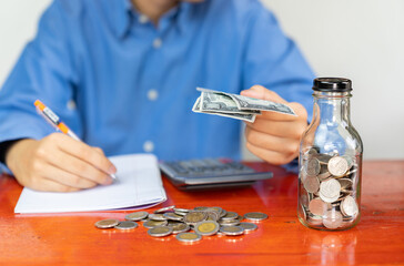 Accounting write on notebook and hold dollar