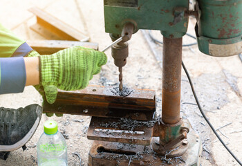 Craftsman use old drill in construction site.