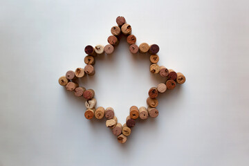 Wine corks octagram star composition isolated on white background from a high angle view
