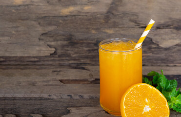 Orange juice fruit smoothies yogurt drink yellow healthy delicious taste in a glass slush for weight loss on wooden background.