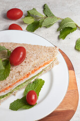 Delicious and healthy sandwich on white plate.