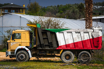 Dump truck with the image of the national flag of Kuwait is parked against the background of the...