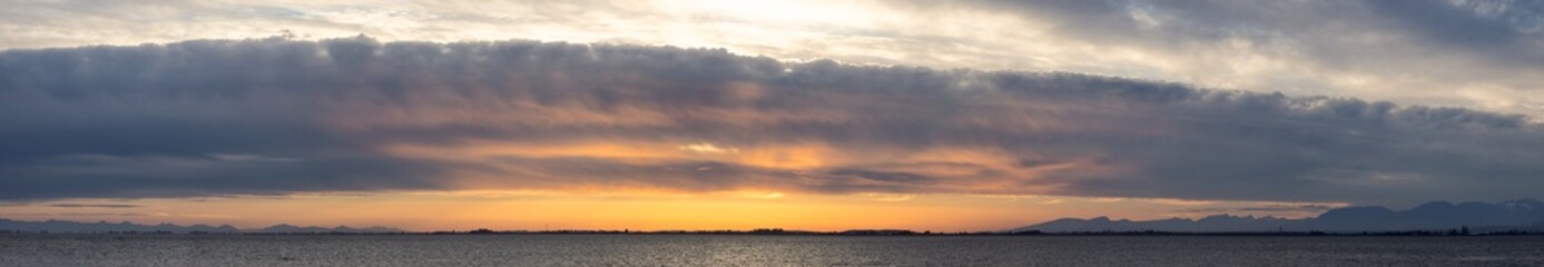 Beautiful Panoramic View of colorful cloudscape during dramatic sunset. Taken in White Rock, Vancouver, British Columbia, Canada.