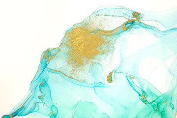Alcohol ink gold and light green abstract background.