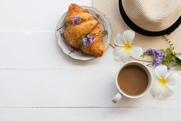 hot coffee, bread croissant and hat of lifestyle woman relax arrangement flat lay style on background white wooden