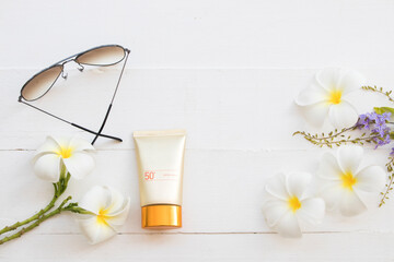 sunscreen spf50, sunglasses cosmetics for skin face of lifestyle woman relax arrangement flat lay style on background white wooden
