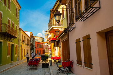 VLORA-VLORE, ALBANIA: Historical multi-colored buildings on the street in the city center. - obrazy, fototapety, plakaty