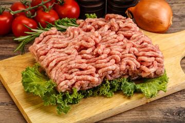 Raw pork minced meat over board