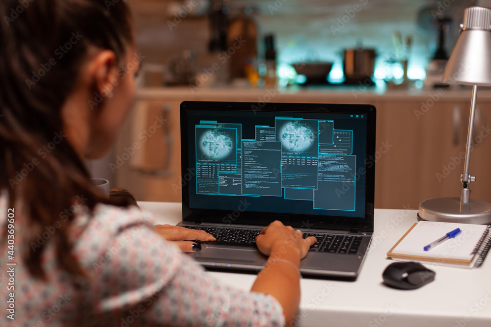 Poster female hacer cracking security firewall late at night from home. programmer writing a dangerous malw