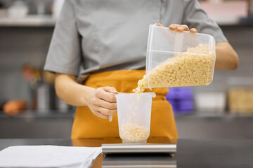 Pastry chef girl prepares the ingredients for her dishes