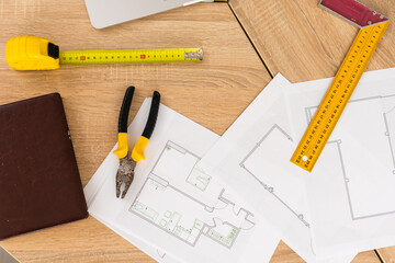 Architect working on blueprint. Architects workplace - architectural project, blueprints, ruler,...
