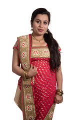 Beautiful young girl posing in Indian traditional saree on white background.