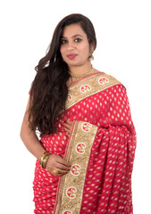 Fototapeta premium Beautiful young girl posing in Indian traditional saree on white background.