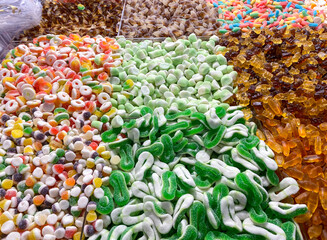 Closeup background from colorful sweets of sugar candies. Assortment tasty gummy