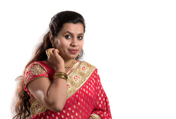Beautiful young girl posing in Indian traditional saree on white background.