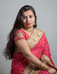 Beautiful young girl posing in Indian traditional saree on white background.