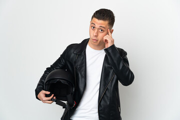 Caucasian man with a motorcycle helmet isolated on white background thinking an idea