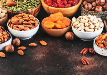 Nuts and dried fruits. Healthy snacks. Dried apricots, figs, raisins, pecans, walnuts, hazelnuts, almonds and other. Brown background