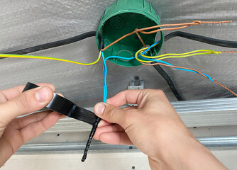 Electrical wiring of the junction box, installation, twisting of the box by an electrician.