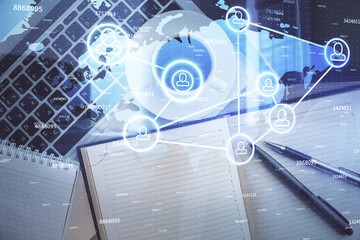 Naklejka premium Social network hologram drawings over computer on the desktop background. Top view. Double exposure.