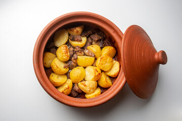From traditional delicious Turkish food; potato and meat dish in casserole (Turkish name; Guvec tas kebabi, tandir)