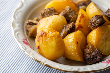 From traditional delicious Turkish food; potato and meat dish in casserole (Turkish name; Guvec tas kebabi, tandir)