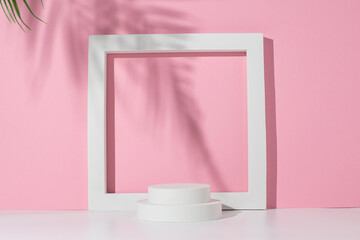 Podium white square, circles for presentation under the shadow of palm leaves on a white pink...