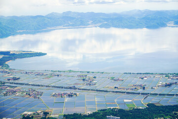 福島県・磐梯山から見下ろす田植え後の、猪苗代の町と猪苗代湖