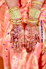 Naklejka premium Indian Bride on the eve of her Hindu or Indian Wedding Ceremony day with henna on her hand