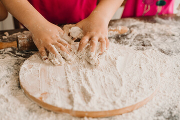person kneading dough