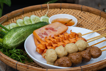 Fried meatballs and hot dog skewers to make it easy to eat on a walk-in size Fried meatballs are popular street food as they are easy to eat for parties. Street food concept.