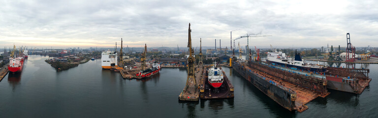 Sunrise panorama Remontova shipyard with ships in the drydocks . Gdansk, Poland, drone footage, natural light..