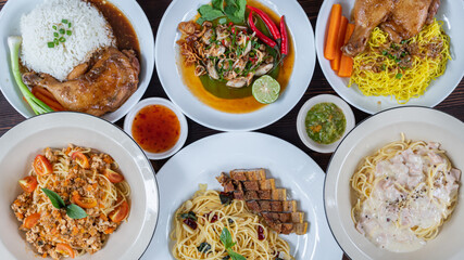Many dishes are served on white plates and then prepared on wooden tables for friends and family members to enjoy at the party. Preparing lots of food to prepare for the party.