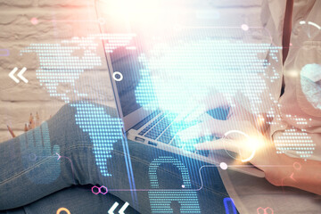 Double exposure of woman hands working on computer and world map hologram drawing. International technology business concept.