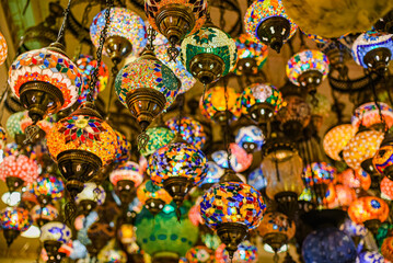 Fototapeta na wymiar traditional handmade turkish lamps in souvenir shop. Mosaic of colored glass.