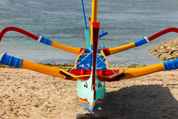 brightly painted fishing outriggers on the beach at Sanur, Bali, Indonesia