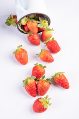 Strawberries, various beautiful strawberry in a white mug on white background, selective focus