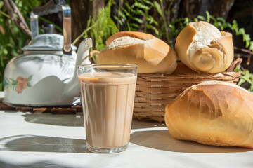 Breakfast in Brazil, bread, a pot of coffee in an American cup of milk and milk on an old white...