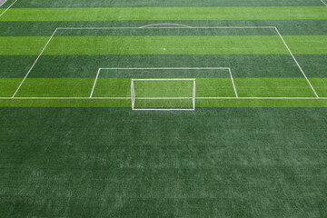 Partial lawn of football field and top rear view of goal