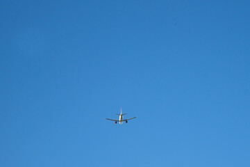 An abstract of plan or airplane in upper view is flying on the blue sky. Present concept of travel and tourism industry will be recovery after vaccination to prevent Covid-19. 