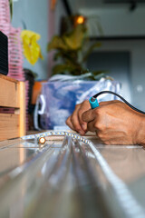 Hand holding solder. welding LED strips for electronics jobs. making connections for a led strip.