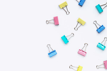 Colorful office paper clips on white background.